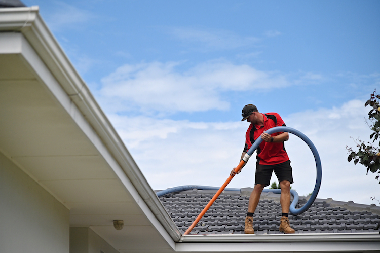 Professional Gutter Cleaning Technician Cleaning a Gutters - K-Guard Rocky Mountains