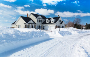 Street view of a house surrounded by snow