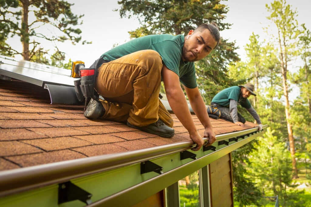 Image of K-Guard employees performing a gutter inspection