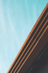 View from underside of dark artistically designed gutter. Seam in gutter.