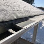 LeafFilter being removed from a home. There is a piece missing. The piece still attached is mostly covered in ice. Ice Damming. Micro Mesh Guard. Guard needs maintained. Regular Cleanings. 