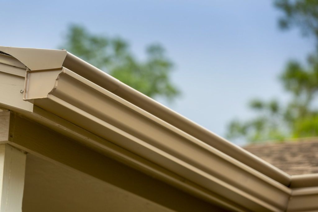 Close-up of the curved hood and deep trough profile on a K-Guard gutter system