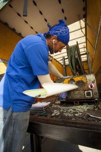 K-Guard crew member fabricating a seamless gutter section on site for a Colorado Springs area home