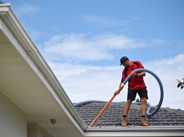 Professional Gutter Cleaning Technician Cleaning a Gutters - K-Guard Rocky Mountains