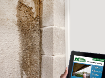 Inspector in basement on tablet, looking at KGuard's Website. Water seepage on basement wall. Water damage. Wet cement wall. KGuard Solution. Poor Drainage Leads to Foundation Issues. Foundation risks. water drainage problems.