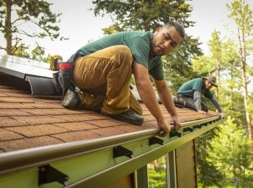 Image of K-Guard employees performing a gutter inspection