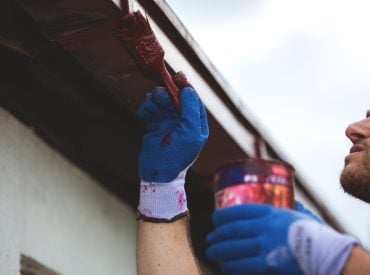 Construction,Work,With,A,Brush,Painting,The,Gutter
