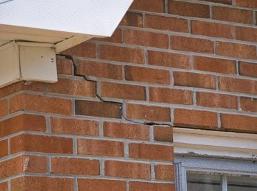 Crack in brick facade on home. The wall is separating at the mortar joints. Foundation issues. Foundation settling. wall separation. water drainage issues.